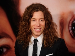Snowboarder Shaun White  walks the red c