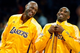 Lakers teammates Lamar Odom and Kobe Bryant share a light moment before the start of a game against