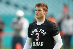 MIAMI GARDENS, FL &#8211; JANUARY 08: New York Jets quarterback Zach Wilson (2) wears a shirt in pregame to tribute to Jamar H