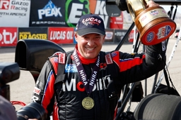 LAS VEGAS, NV &#8211; APRIL 16: Tony Stewart (314 TA) Mobil 1 McPhillips Racing Top Alcohol Dragster holds up his Wally trophy