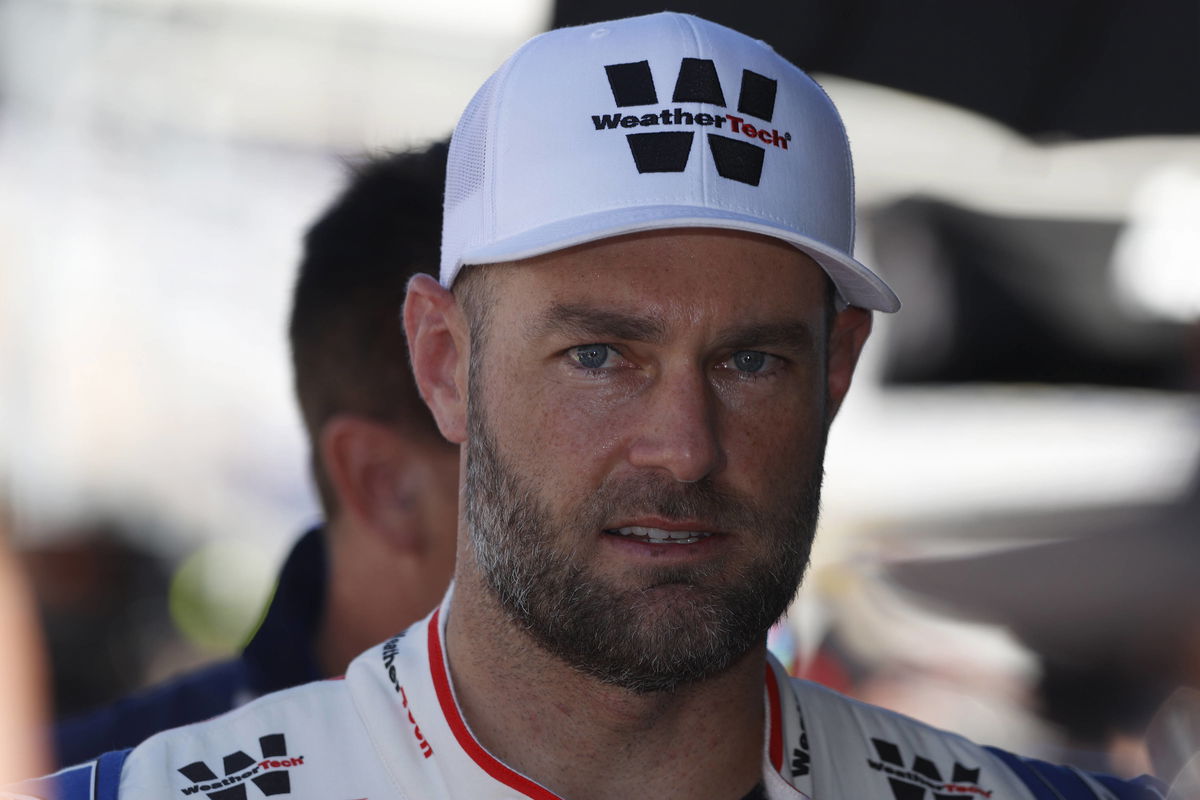 CHARLOTTE, NC &#8211; OCTOBER 12: Shane Van Gisbergen ( 97 Kaulig Racing WeatherTech Chevrolet) talks with his crew during qua