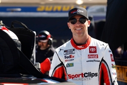 CHARLOTTE, NC &#8211; OCTOBER 12: Denny Hamlin ( 11 Joe Gibbs Racing Clips Haircuts Toyota) talks with members of his crew dur