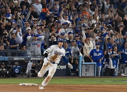 Los Angeles Dodgers designated hitter Shohei Ohtani rounds first after hitting an rbi-single in the fourth inning to giv