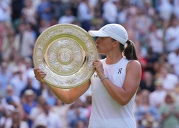 Iga Swiatek of Poland kisses with the Venus Rosewater Dish after winning the Ladies Singles Final on day thirteen of The