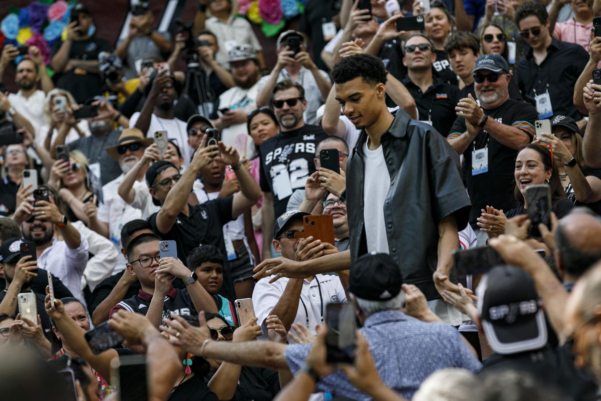 June 24, 2023, San Antonio, Texas, USA: Spurs fans cheer on Victor Wembanyama, the No. 1 overall NBA draft pick, as he m